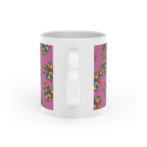 Autism Puzzle Heart Mug — Colorful Love Coffee Cup (Pink Background)